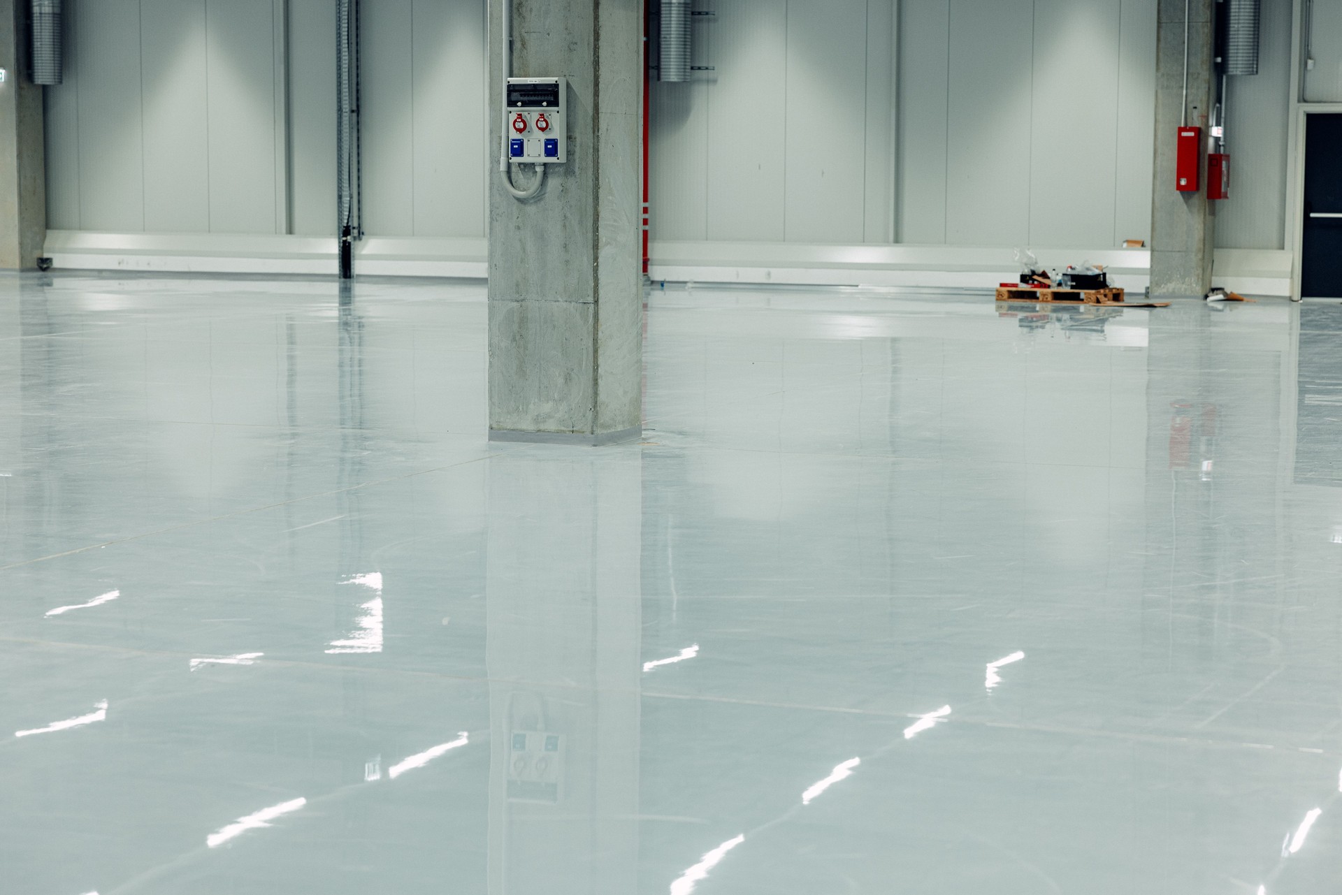 Epoxy Coating System, Industrial Resin Flooring in Modern Warehouse. Concrete Floor Polishing